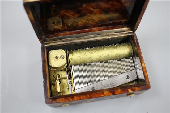 A late 19th century Swiss gold mounted tortoiseshell musical box, inset with a miniature of a young lady, width 8cm depth 5.5cm height